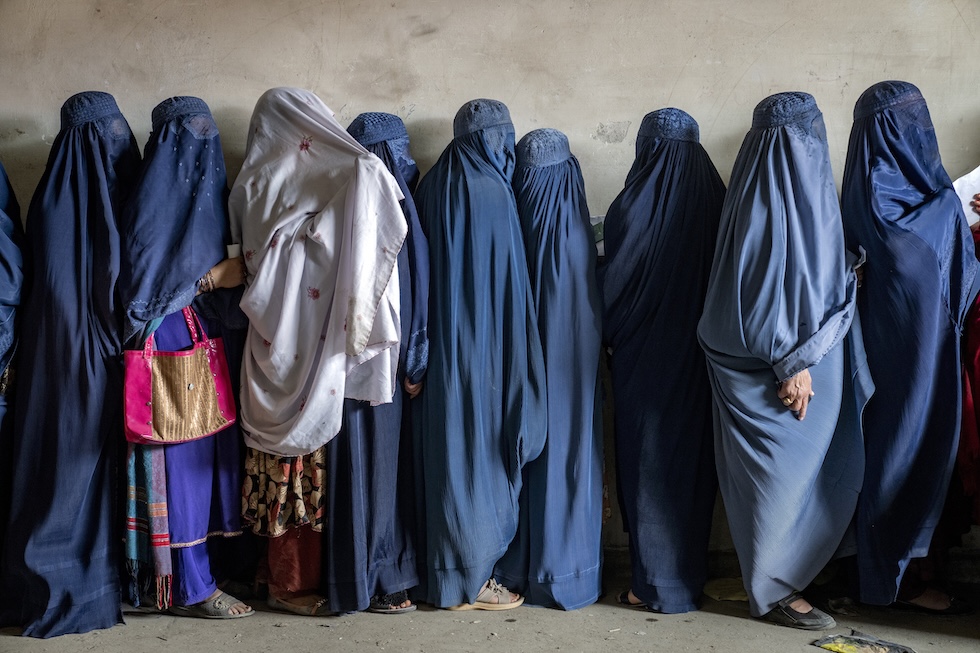 Alcune donne in attesa di ricevere aiuti umanitari a Kabul, nel 2023 (AP Photo/Ebrahim Noroozi, File)