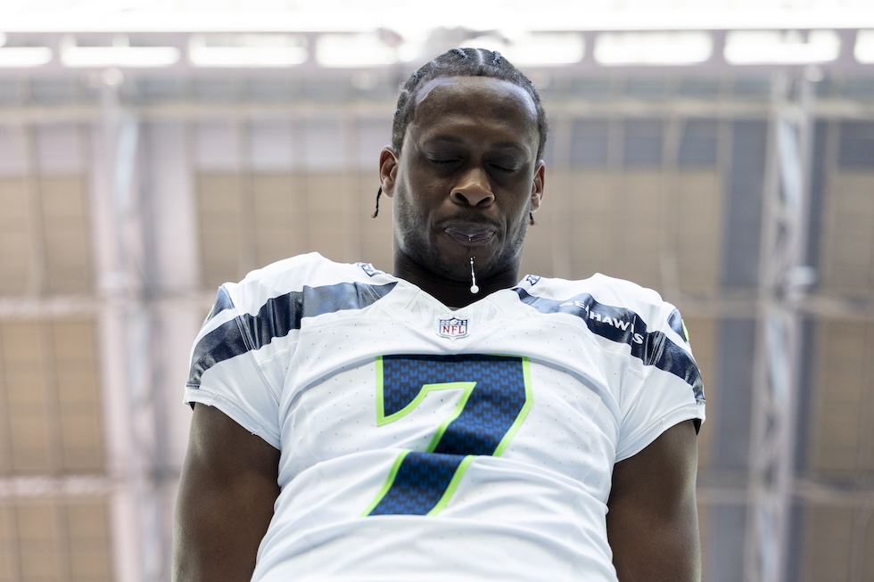 Il quarterback Geno Smith dei Seattle Seahawks sputa per terra prima della partita, durante l'inno statunitense, 8 dicembre 2024 (Michael Owens/Getty Images)
