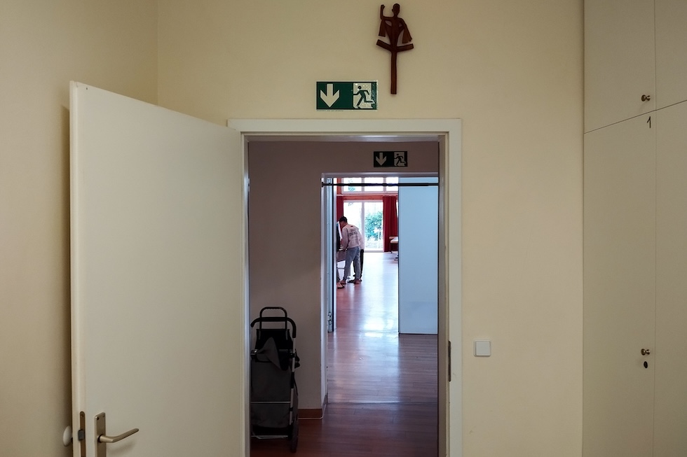 Il corridoio che porta alla sala comune, dove un richiedente asilo sta giocando a biliardino (Rodolfo Toè/il Post)