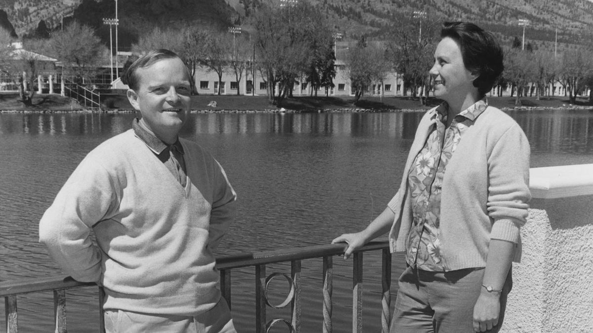 Truman Capote e Harper Lee vicino a un parapetto di fronte a un lago