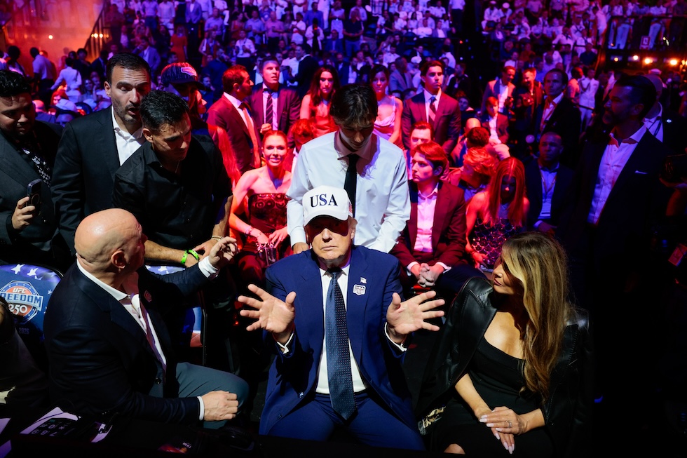 Il presidente degli Stati Uniti Donald Trump all'UFC Freedom 250, un evento organizzato con la collaborazione della Ultimate Fighting Championship, la più importante organizzazione di arti marziali miste al mondo. A sinistra Dana White, grande amico e sostenitore di Trump, e a destra la first lady Melania Trump. Per l'occasione è stata costruita una grossa arena davanti alla Casa Bianca (Evan Vucci/Pool Photo via AP)