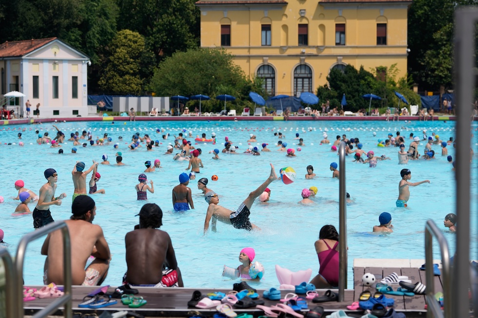 Persone si rinfrescano in piscina (AP Photo/Luca Bruno)
