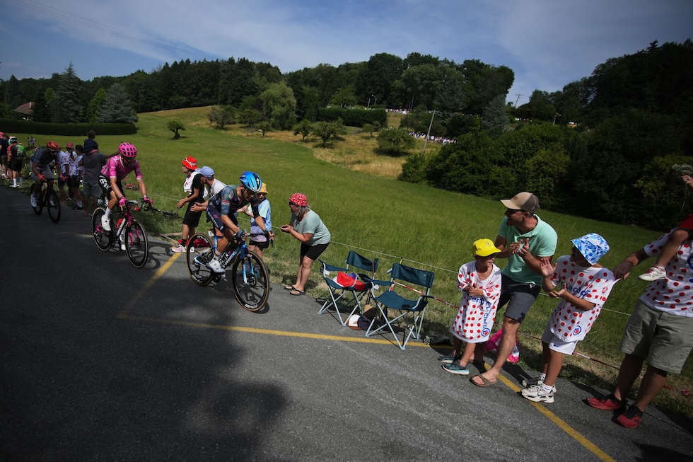 Spettatori e ciclisti alla quindicesima tappa del Tour de France, da Champagnole a Plateau de Solaison (AP Photo/Mosa'ab Elshamy)