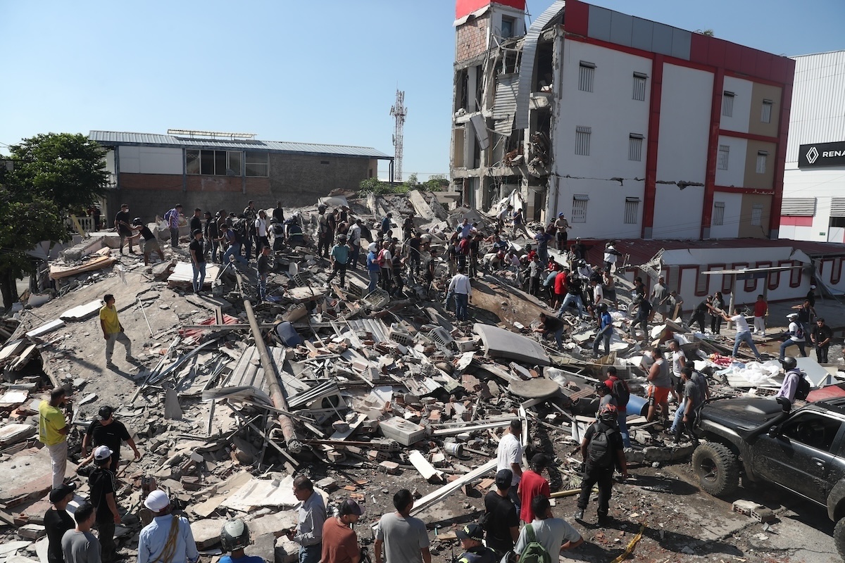 Persone fuori da un edificio crollato a Cali, il 10 agosto 2026 (AP Photo/Santiago Saldarriaga)
