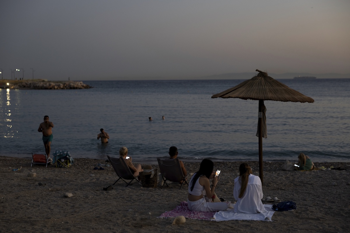 Persone in spiaggia nel tardo pomeriggio